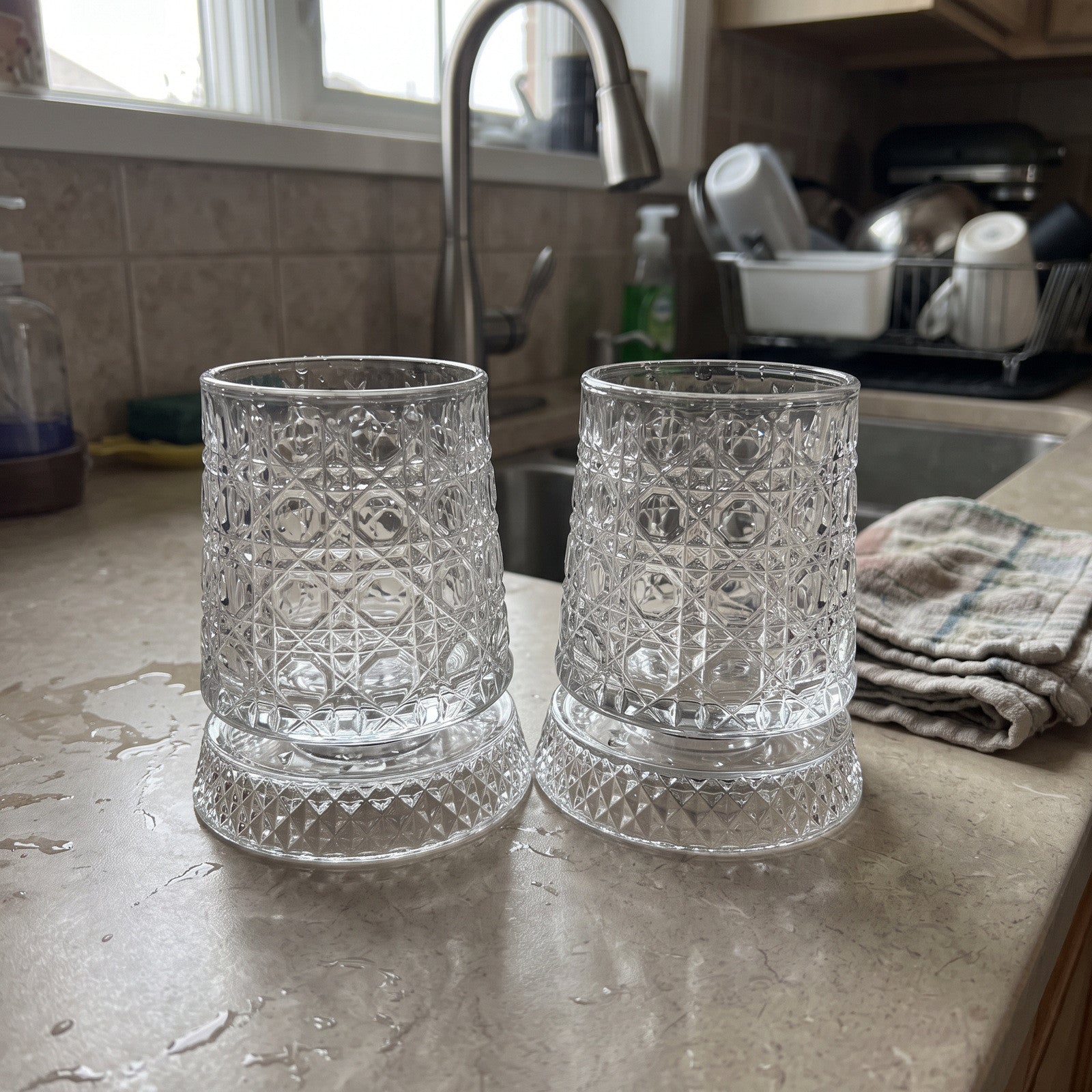 Clean scallop glass pair on a drying counter beside a cloth